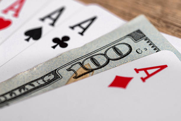 istock four poker aces with 100 dollar bills 518325274