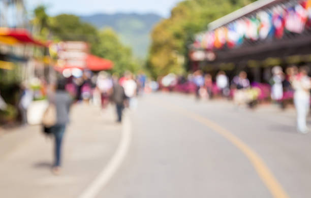 istock Image of abstract blurred tourists walk on the road 518326112