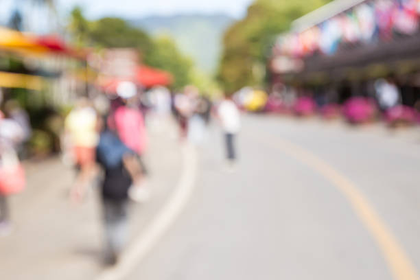 istock Image of abstract blurred tourists walk on the road 518326230