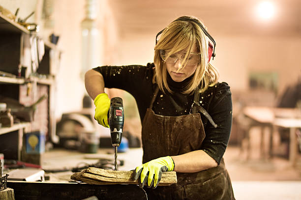istock Blonde woman with electric drill 518327548