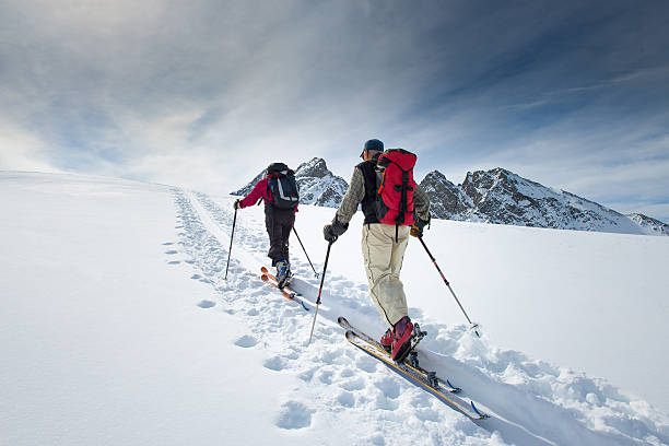 zwei ältere alpine skifahrer - skiing snow sport mountain stock-fotos und bilder