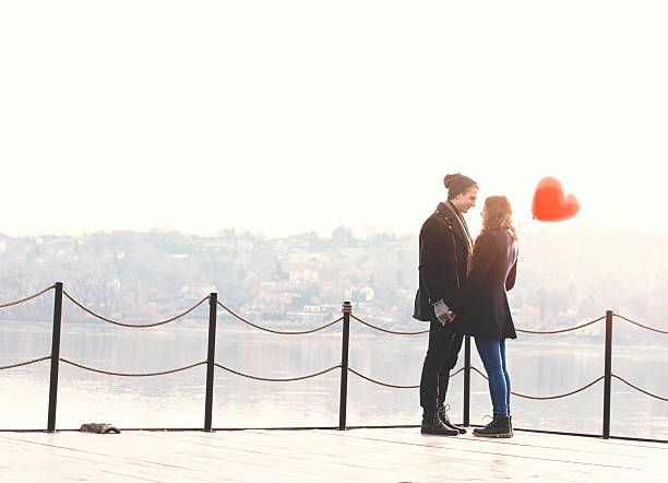 istock Young couple in love at the riverside 518328754