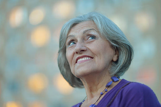 istock senior woman in summer park 518334282