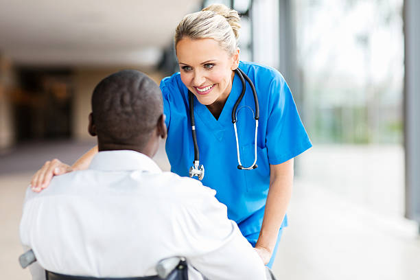 istock female doctor comforting disabled patient 518334972
