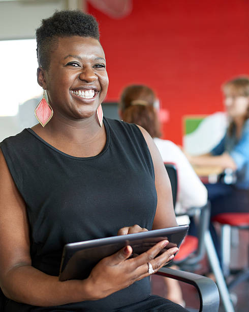 istock Confident female designer working on a digital tablet in red 518337564