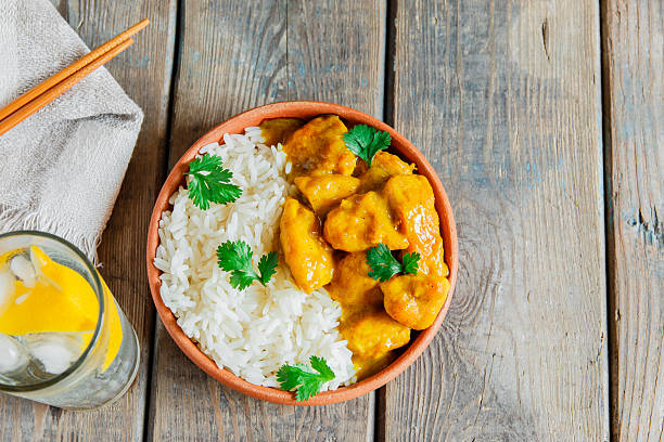 istock chicken curry with rice on a wooden surface 518338758