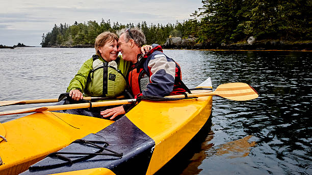 coppia senior kayak - canoeing canoe senior adult couple foto e immagini stock