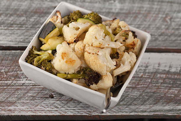 istock Roasted Cauliflower, Broccoli, and Zucchini top view on barn table 518344056