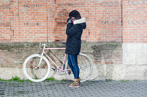 istock Woman with pink vintage Bicycle with white wheels 518344992