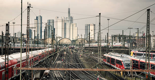Frankfurt Central Station Frankfurt, Germany - March 8, 2016: Frankfurt Hauptbahnhof and skyline of the downtown district on an overcast afternoon. Pictured trains and ICE trains are from DB (Deutsche Bahn). Deutsche Bahn AG is a national railway company in Germany and headquartered in Berlin. DB is also the successor to the former state railways of Germany (Deutsche Bundesbahn). deutsche bahn stock pictures, royalty-free photos & images
