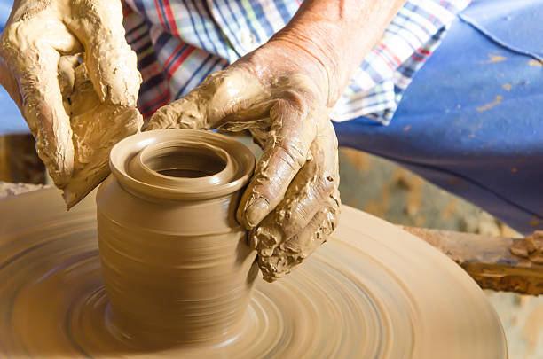 istock Hands of making clay pot ,select focus, close-up. 518347608