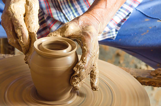 istock Hands of making clay pot ,select focus, close-up. 518347692