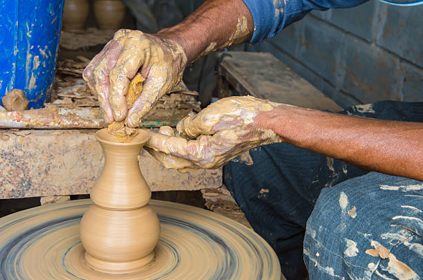 istock Hands of making clay pot ,select focus, close-up. 518349570