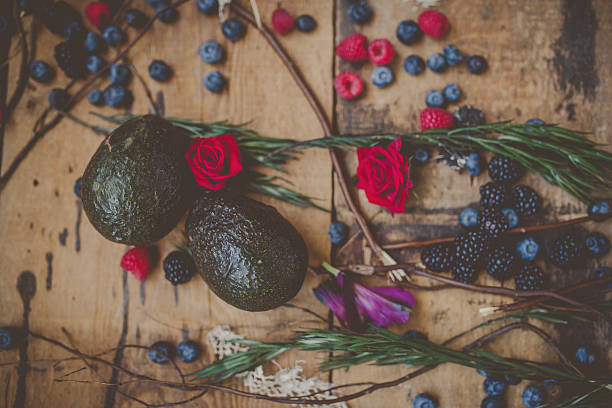 Berries, plums and avocados on barnwood