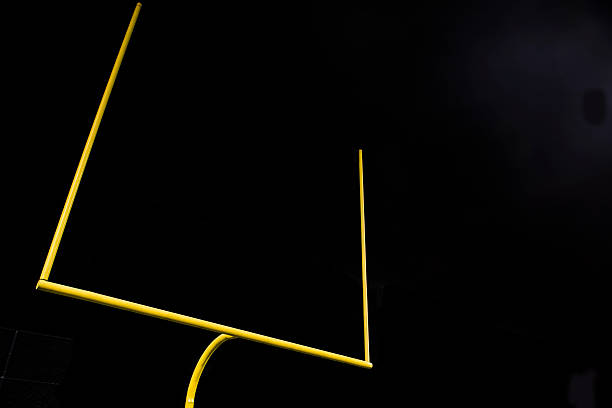 American Football Field Goal at Night Low angle shot of football goal posts in a football stadium at night . goal post stock pictures, royalty-free photos & images