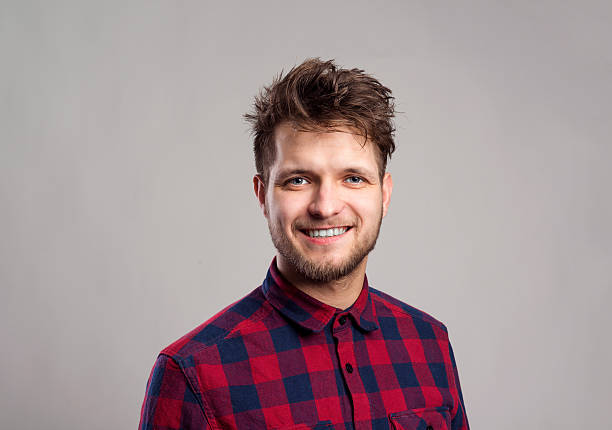 istock Hipster man in checked shirt smiling, against gray background. 518354194