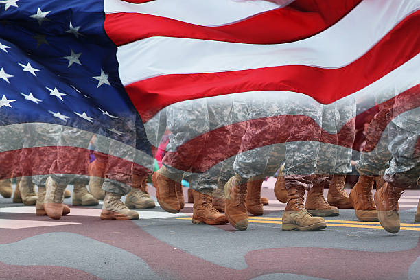 Army Parade & Flag Soldiers dressed in army camouflage in an army parade covered with the flag. usa flag shoes stock pictures, royalty-free photos & images