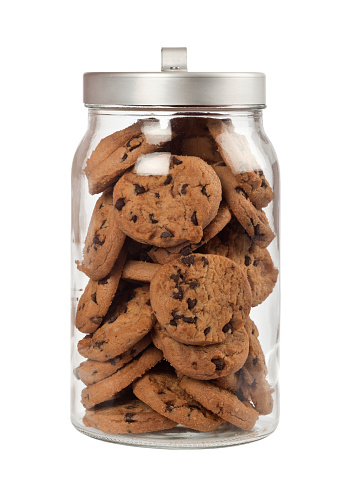 Jar full of chocolate chip cookies isolated on white background