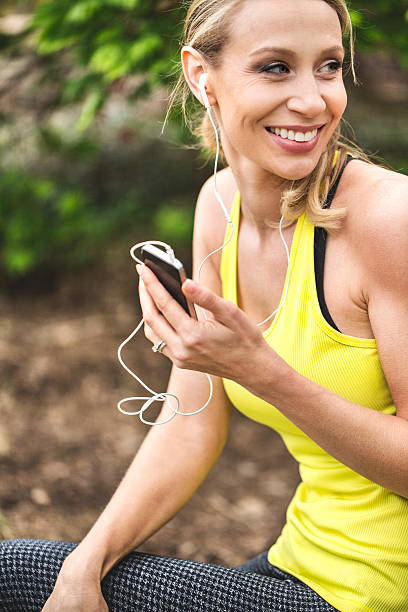 istock Smiling woman adjusting her phone before start running. 518355797