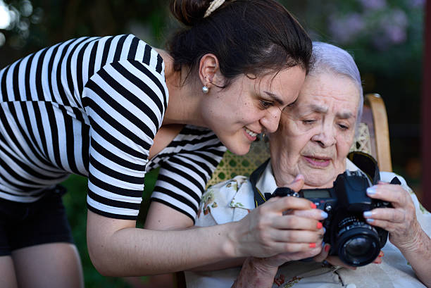 istock grandma holding photo camera 518355870