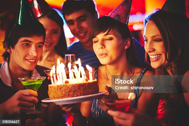 Blowing On Candles In The Dark Stock Photo - Download Image Now - Birthday, Teenager, Blowing