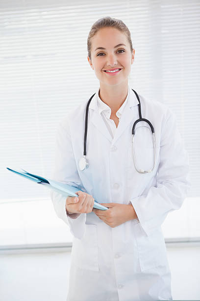 istock Smiling doctor holding some files 518356687