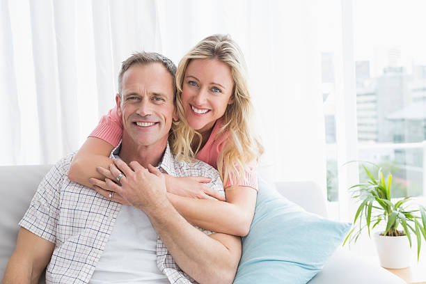 istock Content woman hugging his husband on the couch 518357343
