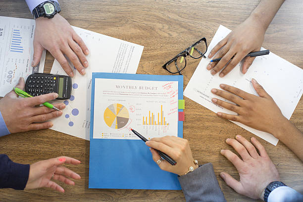 istock Close up of business graphs and papers on a table 518357608