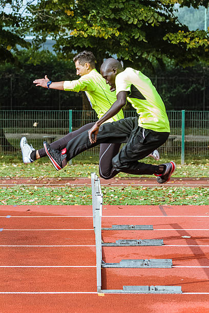 istock Two young men jumping during training in Hurdle Race 518358313