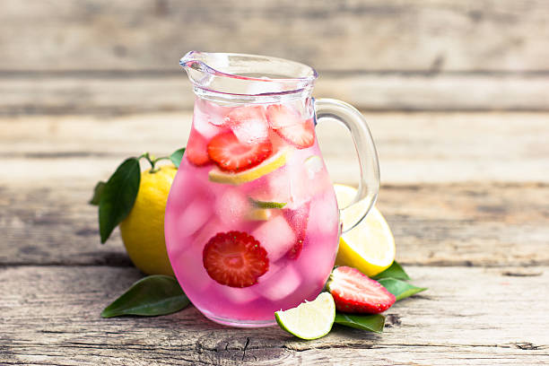 istock Fresh pink lemonade with lemon, lime and strawberries 518358432