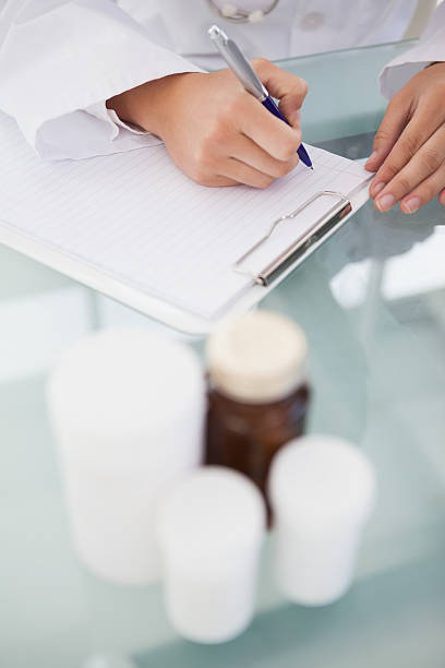 istock Doctor writing out prescriptions 518358527