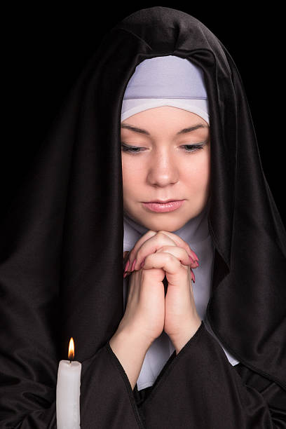 istock Portrait of praying nun 518359926