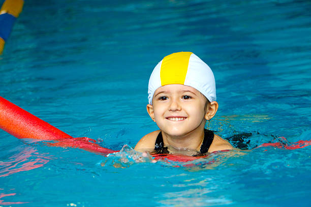 istock Child playing in the pool 518360868