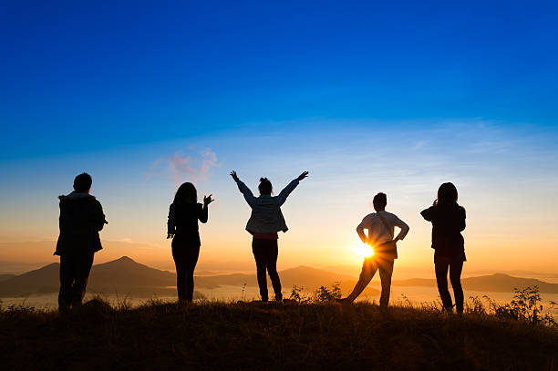 istock sunrise on misty  mountain with women and man 518361636