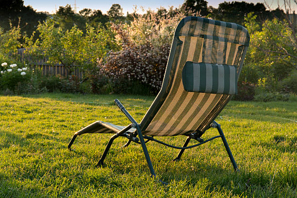 istock chaise longue in the garden at sunset background 518365918
