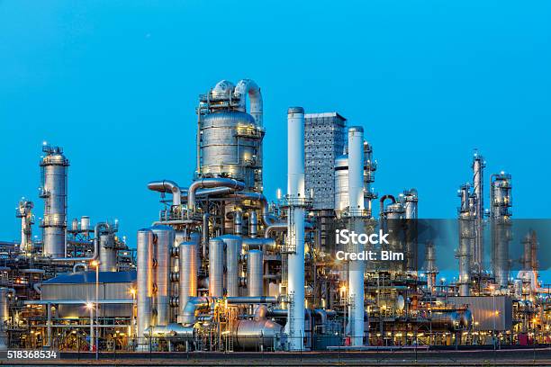 Petrochemical Plant Illuminated At Dusk Stock Photo - Download Image Now - Chemical Plant, Refinery, Oil Refinery
