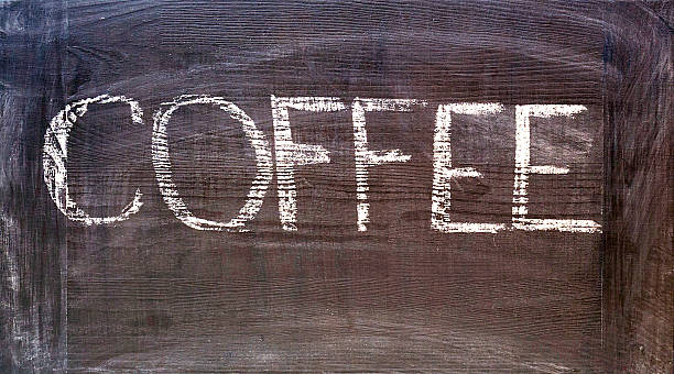 istock hand written coffee word on dark wooden chalkboard 518370646