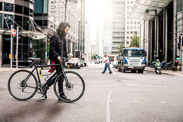 istock Commuter crossing the road in financial district 518372234