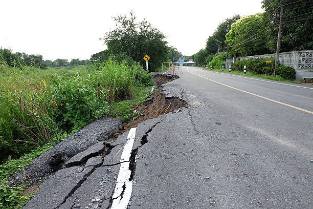 istock Side of the broken asphalt road collapsed after flood 518377387