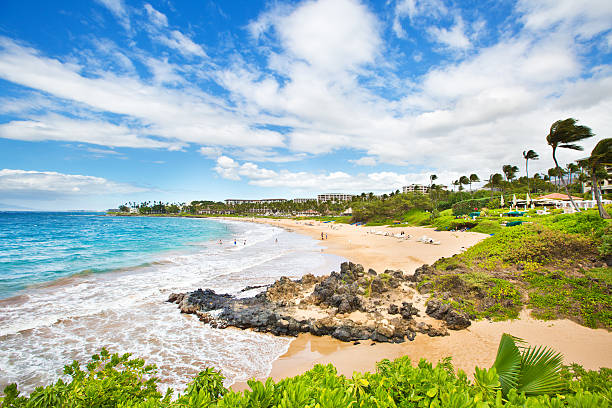 Wailea Beach on the Southwest Shore of Maui Hawaii Resorts and vacation hotels lined the beach at the Wailea Beach on the southwest shore of the island of Maui in Hawaii. A beautiful sandy beach, a popular tourists destination in Hawaii. Photographed in horizontal format. maui stock pictures, royalty-free photos & images