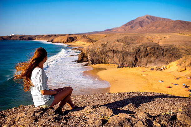 female tourist on papagayo beach - canarische eilanden stockfoto's en -beelden