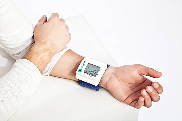 photo of young man’s hand measuring his blood pressure - blodtryck orolig bildbanksfoton och bilder