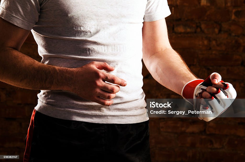 fighter mma fighter is getting ready against brick wall Active Lifestyle Stock Photo