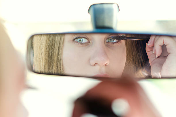 istock Woman putting make up in a car. 518382588