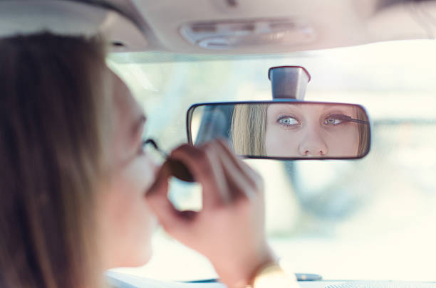 istock Woman putting make up in a car. 518382626