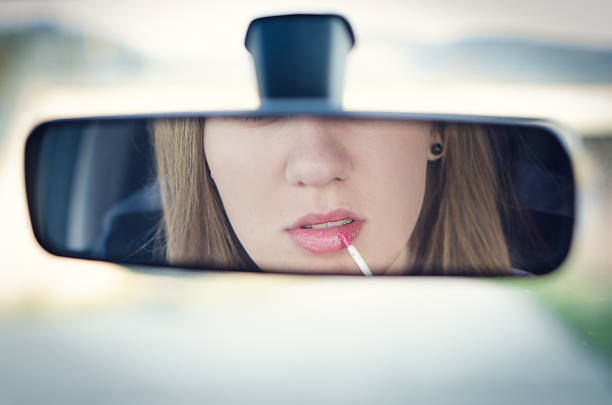 istock Woman putting make up in a car. 518382646