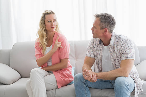 istock Unhappy couple having an argument on the couch 518382799