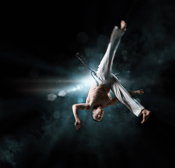 istock combative sport: male fighter trains capoeira 518383032
