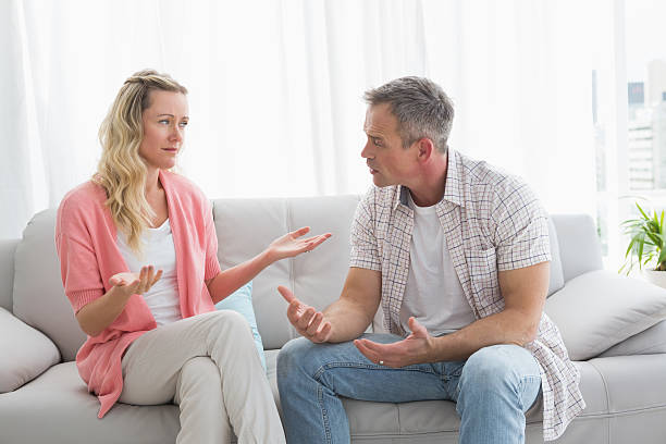 istock Unhappy couple having an argument on the couch 518383209