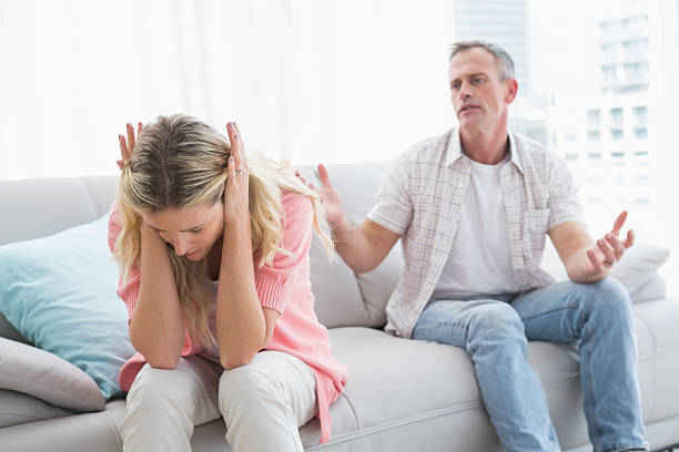istock Woman ignoring her partner on the couch 518383233